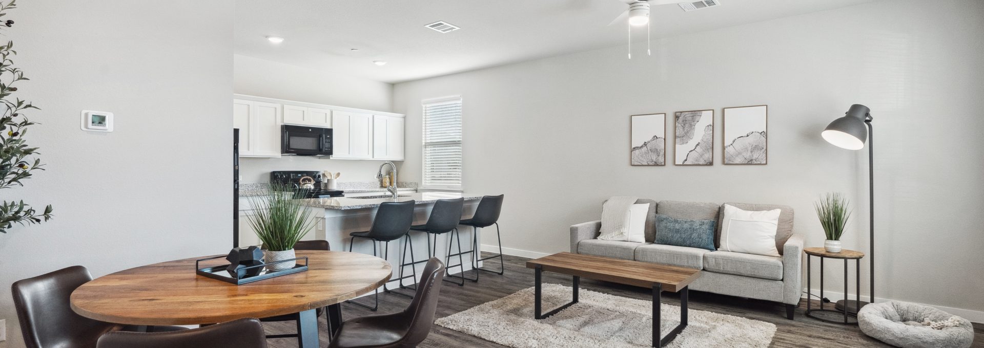 the living room and dining area of a modern apartment at The  Powell