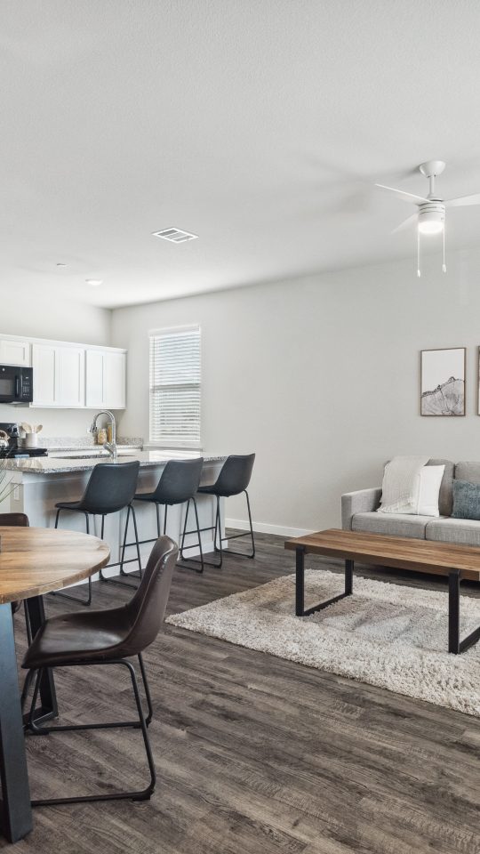 the living room and dining area of a modern apartment at The  Powell