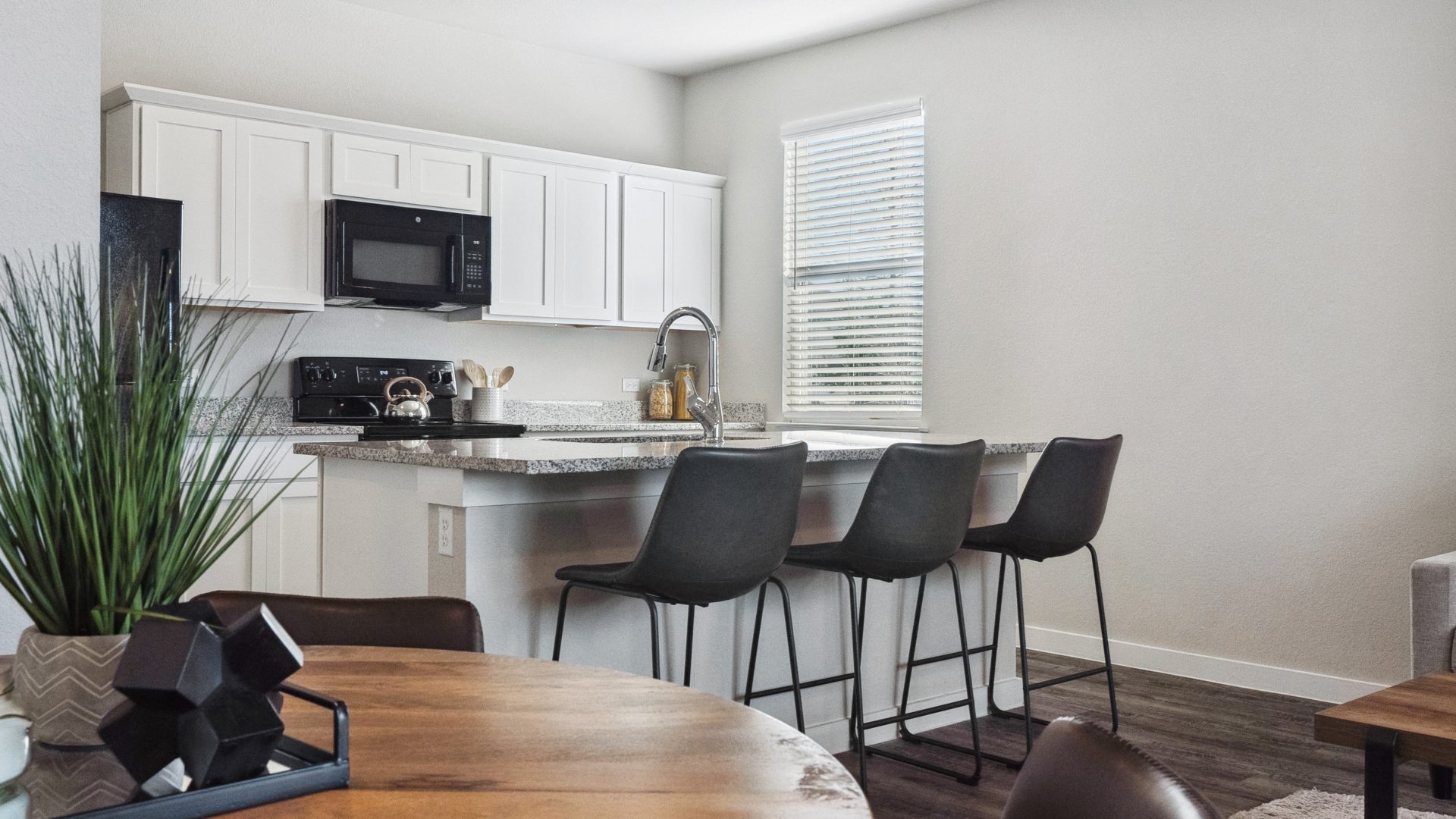 a kitchen and dining area with a white table and chairs at The  Powell