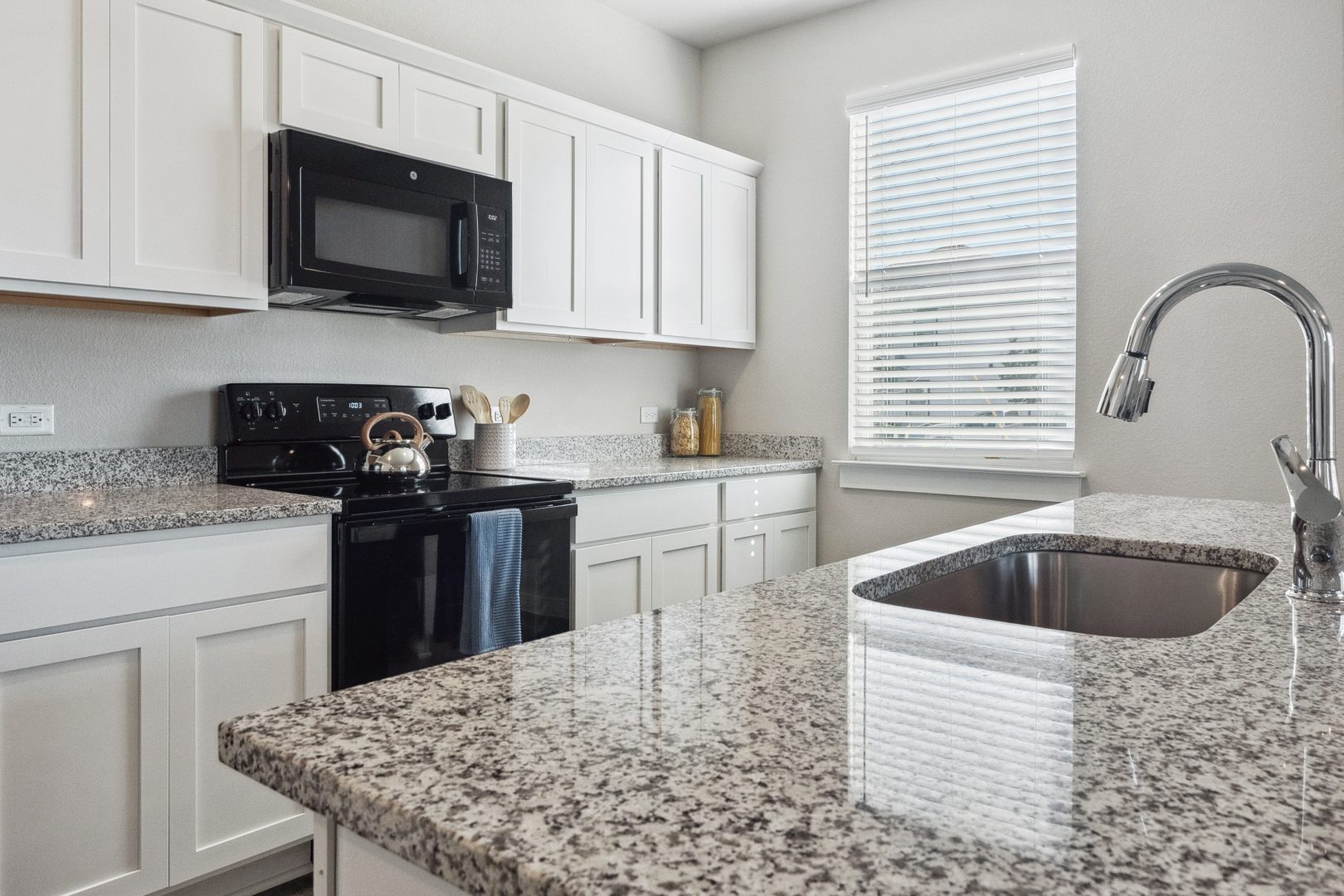 kitchen with granite counter tops and stainless steel appliances at The  Powell