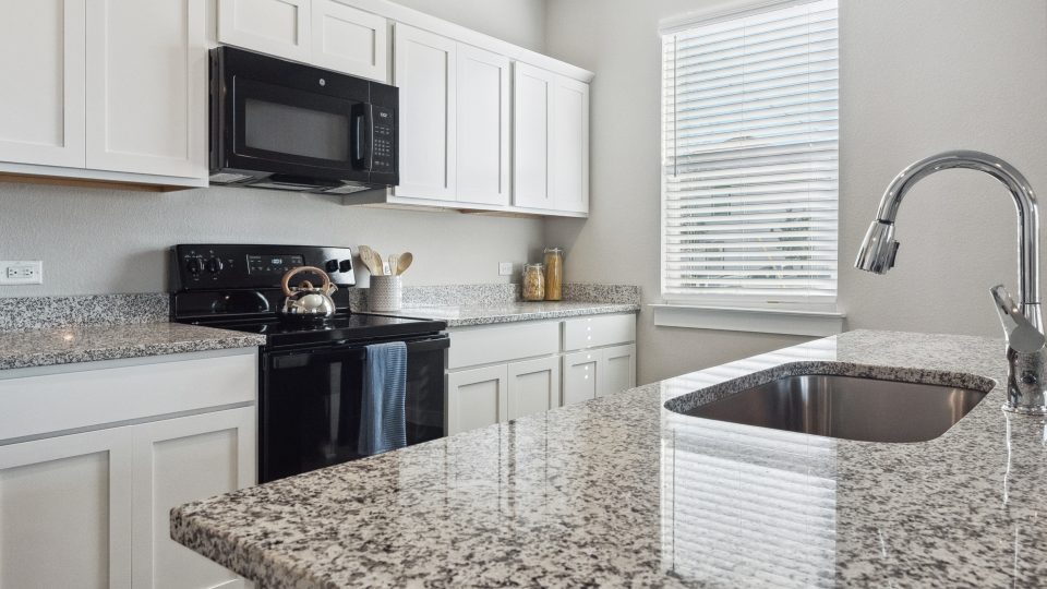 kitchen with granite counter tops and stainless steel appliances at The  Powell