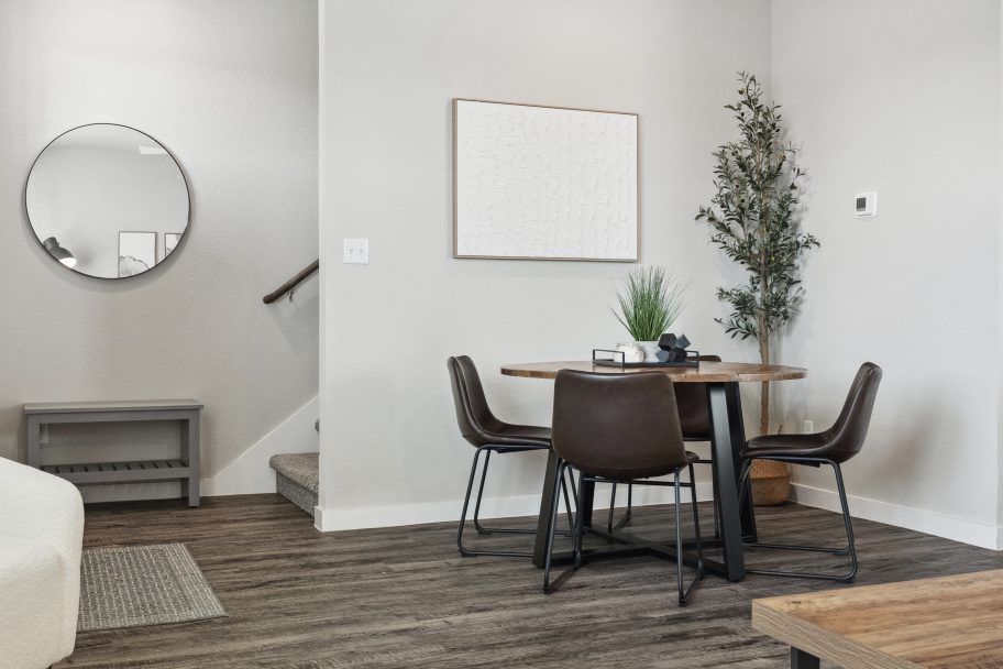 Furnished dining room with a table and chairs inside a model townhome unit at The Powell