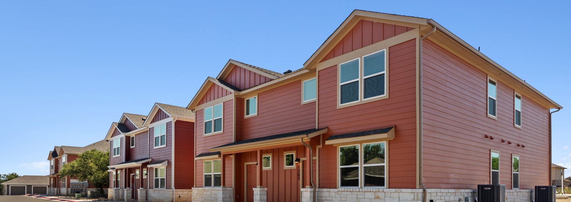 a row of townhomes with red and brown siding at The  Powell