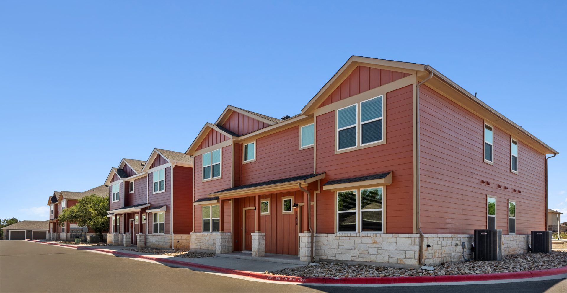 a row of townhomes with red and brown siding at The  Powell