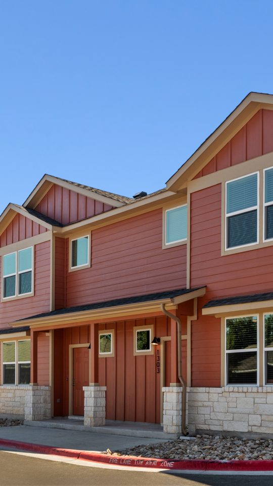 a row of townhomes with red and brown siding at The  Powell