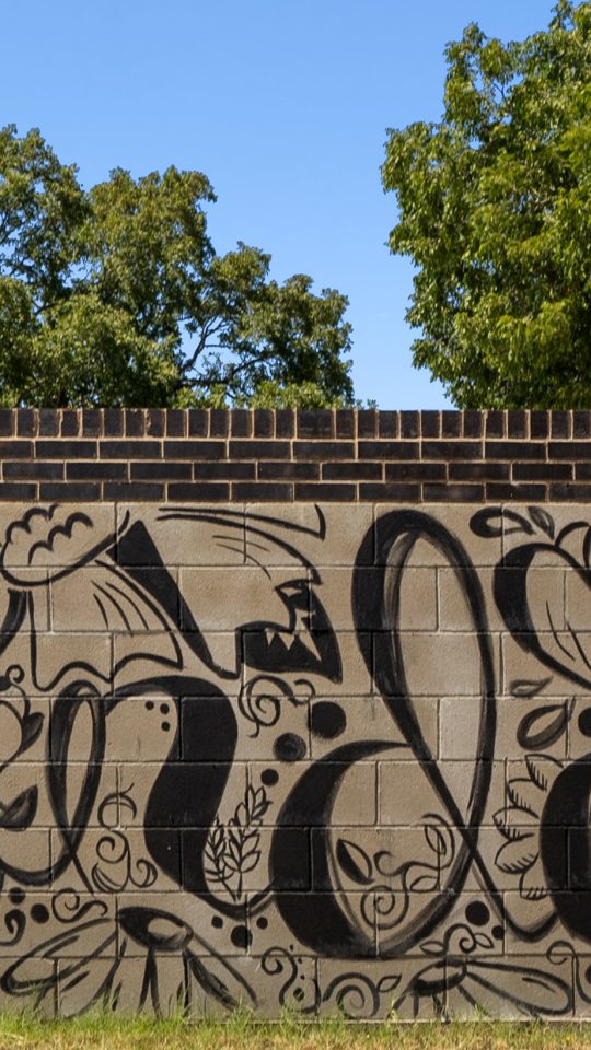 a large mural with black and white writing on it at The  Powell